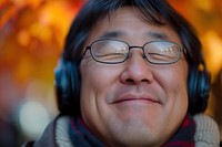 Extreme close up of Cheerful asian person listening to music photography portrait cheerful.