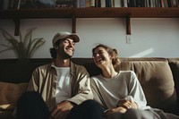 Couple watching movie furniture laughing portrait.