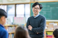 Japan teacher teaching a classroom of students adult intelligence togetherness.