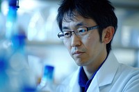 Japanese scientist working glasses adult concentration.