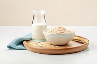 Oat milk glass with oatmeal wooden bowl dairy food refreshment.