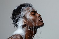 Black man washing hair with shampoo caesar short hair portrait adult head.