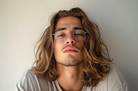 Young man with long wavy hair portrait glasses photography.