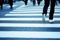 Person walking pedestrian crossing road.