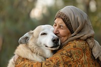 Middle eastern woman hugging elderly dog smiling mammal animal.