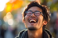 Japanese man laughing glasses smile.