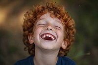 Young british boy laughing baby eyes closed.