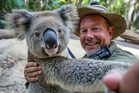 Selfie of koala and zookeeper wildlife portrait smiling.
