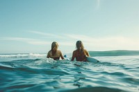 Woman and friend Surfers swimming ocean vacation.