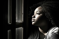 African american chubby female portrait looking window.