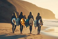 Group of female surfers walking on the beach outdoors surfing nature.