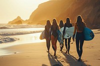 Group of female surfers walking on the beach outdoors vacation surfing.