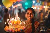 Indian woman celebrating balloon cake birthday.