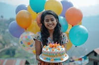 Nepalese young woman celebrating balloon cake birthday.
