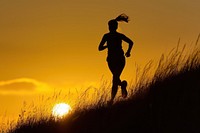 Woman running up hillside backlighting silhouette adult.