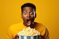 African american guy eating popcorn yellow shock surprised.