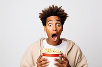 African american guy eating popcorn shock food surprised.