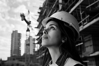An woman architect in front of his construction site portrait hardhat helmet.