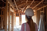 Female architect inspecting an under construction home hardhat helmet adult.