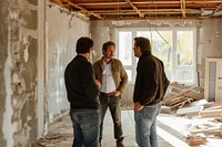 Four architects inspecting an under construction home adult togetherness architecture.