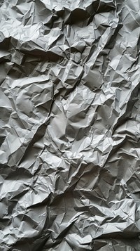 Old silver crumpled paper backgrounds aluminium textured.