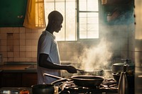 A African man cooking kitchen home food.