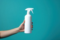Hand holding white spray bottle container cleaning hygiene.