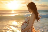 Pregnant woman outdoors nature beach.