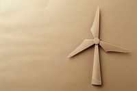 Brown paper punch into the shape of a wind turbines electricity copy space propeller.