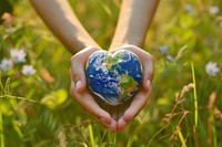 Hand holding planet Earth in shape of heart earth space environmentalist.