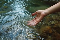 Hand touching the river water outdoors finger nature.