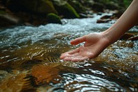 Hand touching the river water finger tranquility barefoot.