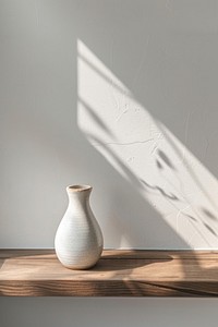 Minimal ceramic empty vase on wooden shelf in clean room white architecture simplicity.