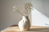 Minimal empty freeform handmade ceramic vase on wooden table flower plant white.