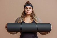 Fat woman holds an exercise mat portrait sports photo.