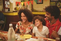 Brazilian family spend time in the restaurant laughing adult child.