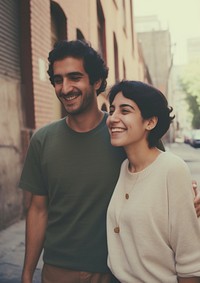 Hispanic cute couple street laughing portrait.