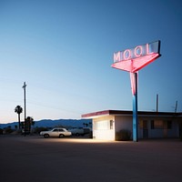 Retro neon night of motel in california architecture building vehicle.