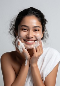 Woman cleaning her face smile portrait relaxation.
