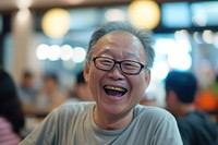 Elder Singaporean Joyful laughing portrait glasses.