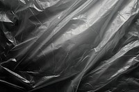 Cling plastic wrap over black background backgrounds monochrome crumpled.