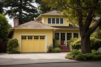 House with garage and a front driveway architecture building yellow.