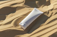 Tube skincare packaging  outdoors nature sand.