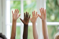 Raise hands of 4 mixed races children finger adult togetherness.