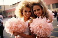 Two females cheerleaders holding pom poms portrait adult photo.