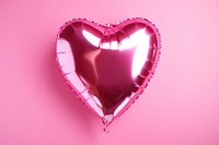 Photo of a foil balloons heart pink heart shape.