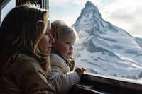 Kid with mother in a train mountain window portrait.