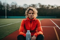 Athletic woman sitting on a bench running bottle adult.