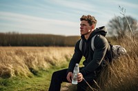 Athletic man sitting on a bench portrait outdoors nature.