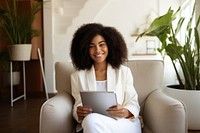 Business black woman sitting and holding tablet computer smiling adult.